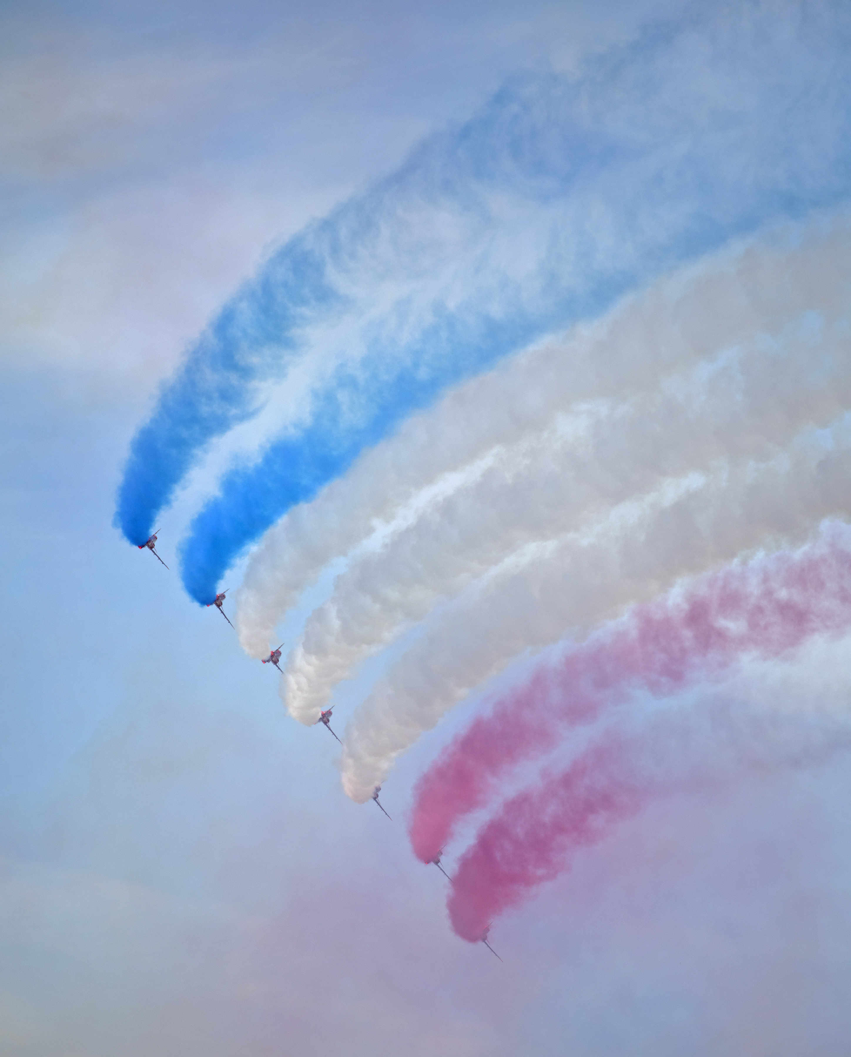 Image of the RAF Red arrows in formation with Union Jack smoke trails.